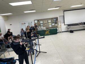 Youth competitors shooting air rifles at the Izaak Walton League table during the 2021 Championship