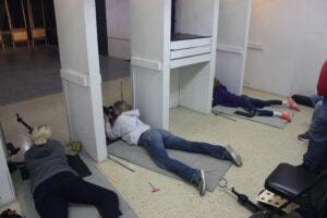 Competitors in prone position on the floor at the 2021 Iowa State Air Rifle Championship