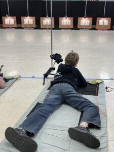 Youth competitor in prone position at the 2021 Iowa State Air Rifle Championship