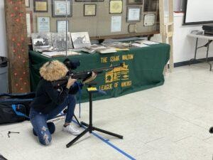 Competitor kneeling at the Izaak Walton League table during the 2021 Air Rifle Championship
