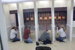 Two youth competitors standing and shooting at the 2021 Iowa State Air Rifle Championship