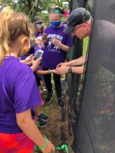 Scout leader showing youth members an outdoor conservation exhibit